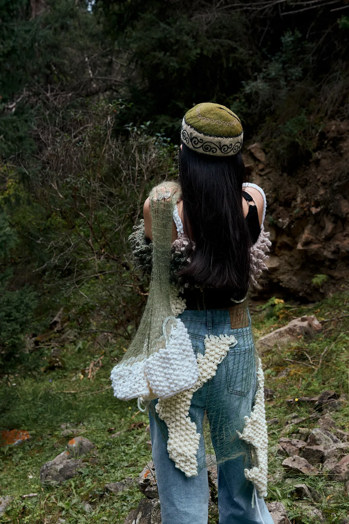 Back view of the knitted garment and mohair net