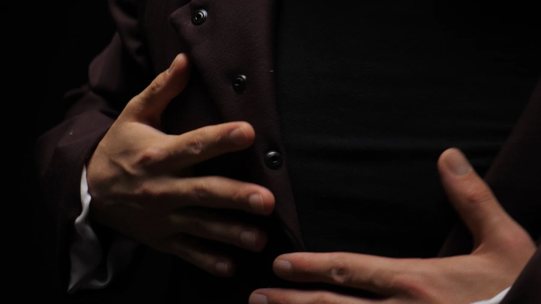 Hands on the jacket buttons