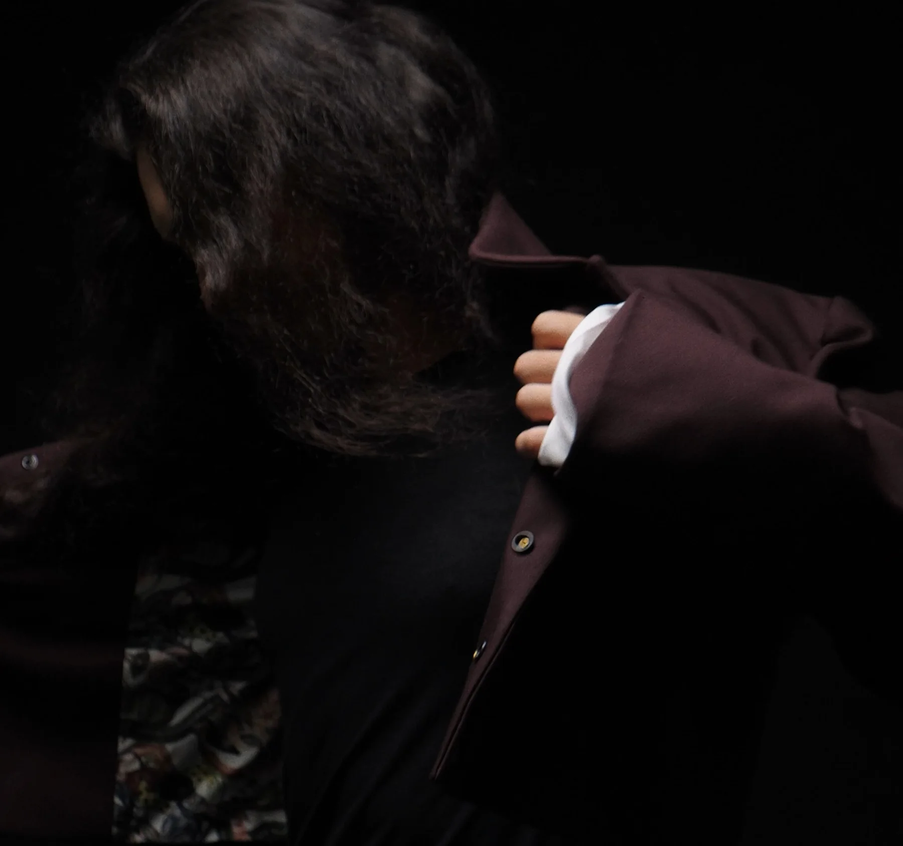 Opening the burgundy jacket to reveal the printed lining