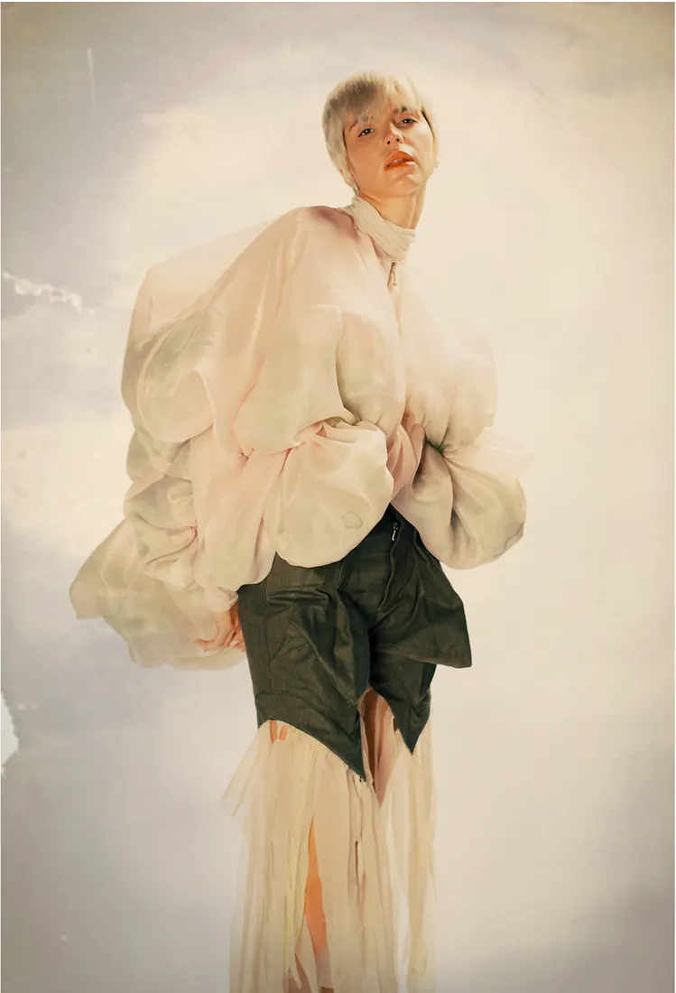 Model in a ruffled blouse and fringed skirt