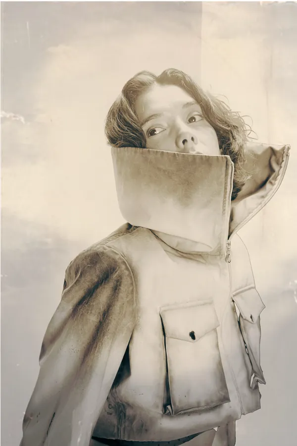 Model hiding her face behind the jacket's tall collar