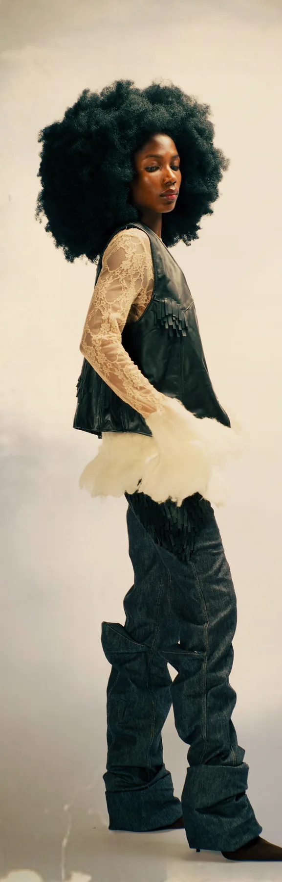 Model in a dark vest and high boots