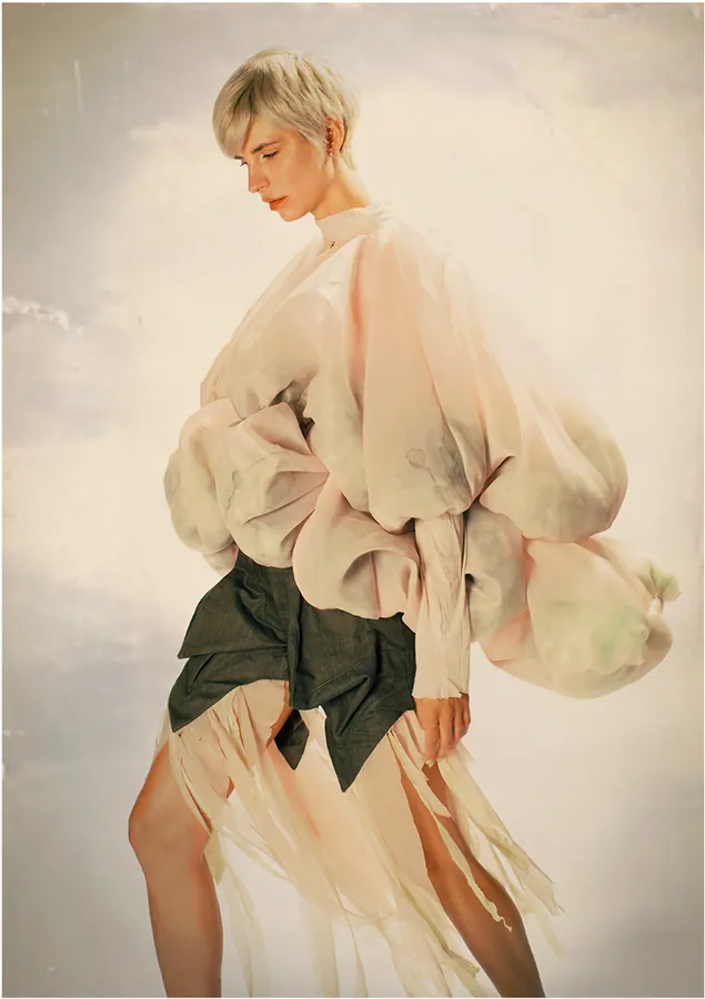 Pale voluminous sleeves and fringed skirt